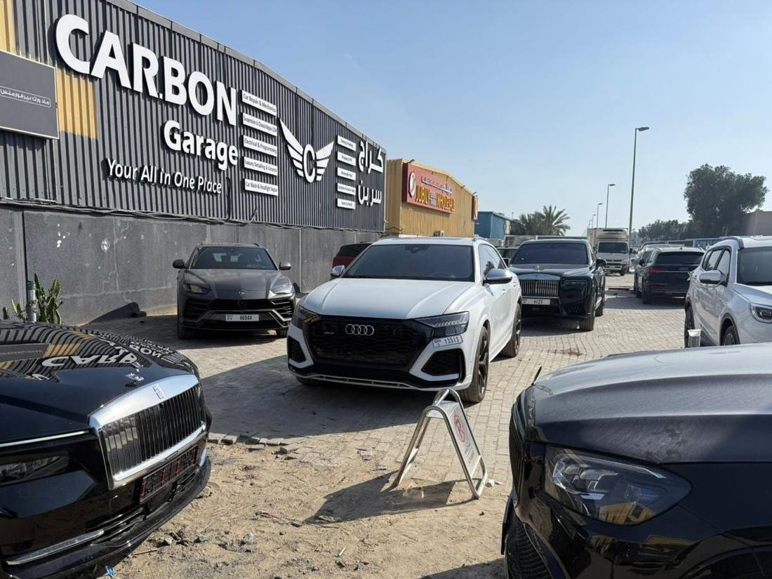 The Carbon Garage workshop in Al Quoz, Dubai, with a Rolls-Royce, Lamborghini Urus and Audi RS Q8 parked outside
